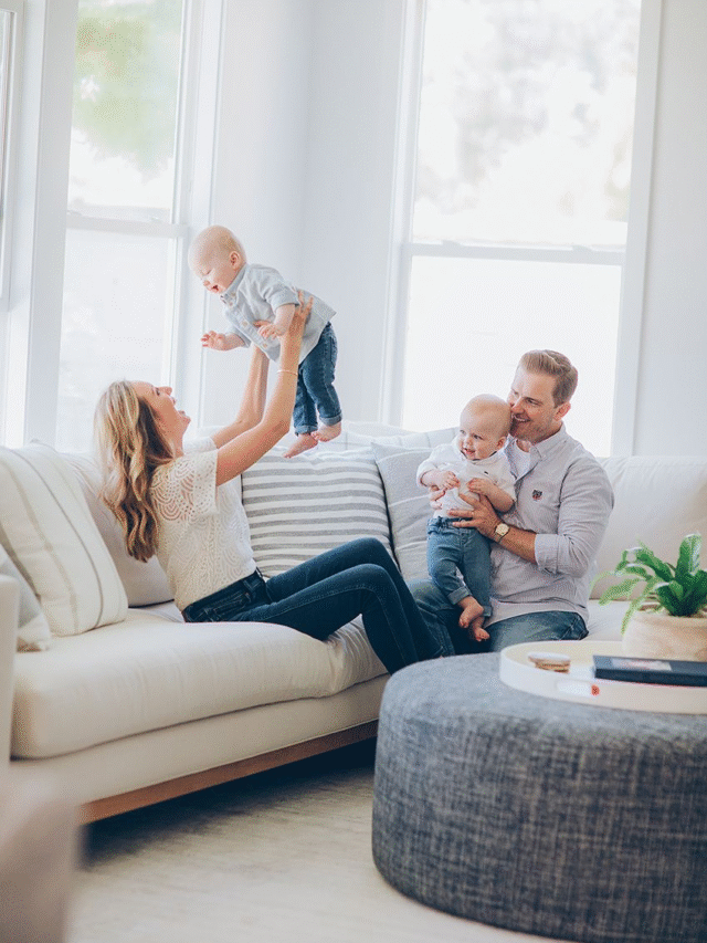 Happy family with twin babies at home