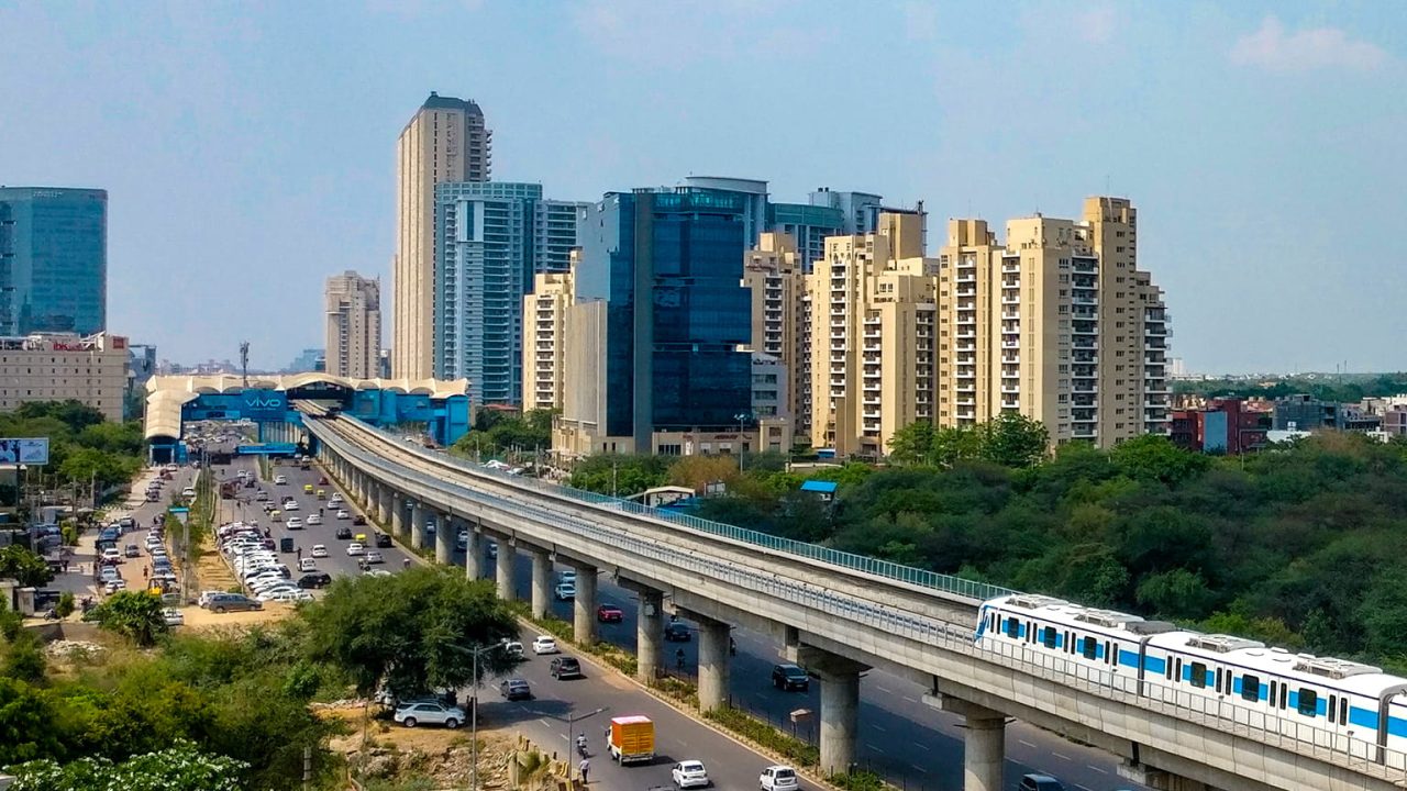 Modern apartments with Delhi Metro and city road view