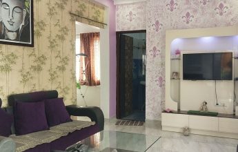 Living room with sofa, TV, and art