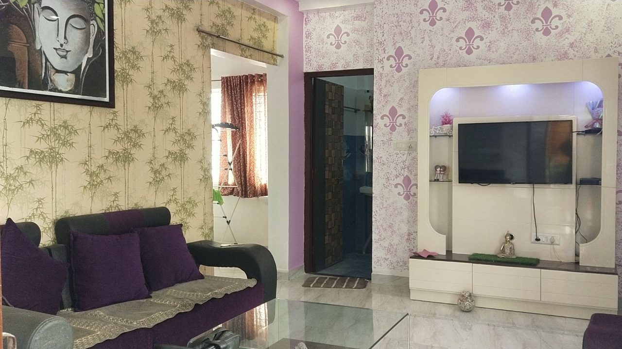 Living room with sofa, TV, and art