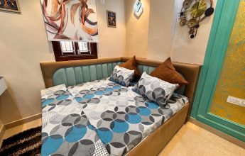 Compact bedroom with designer bed and wall decor