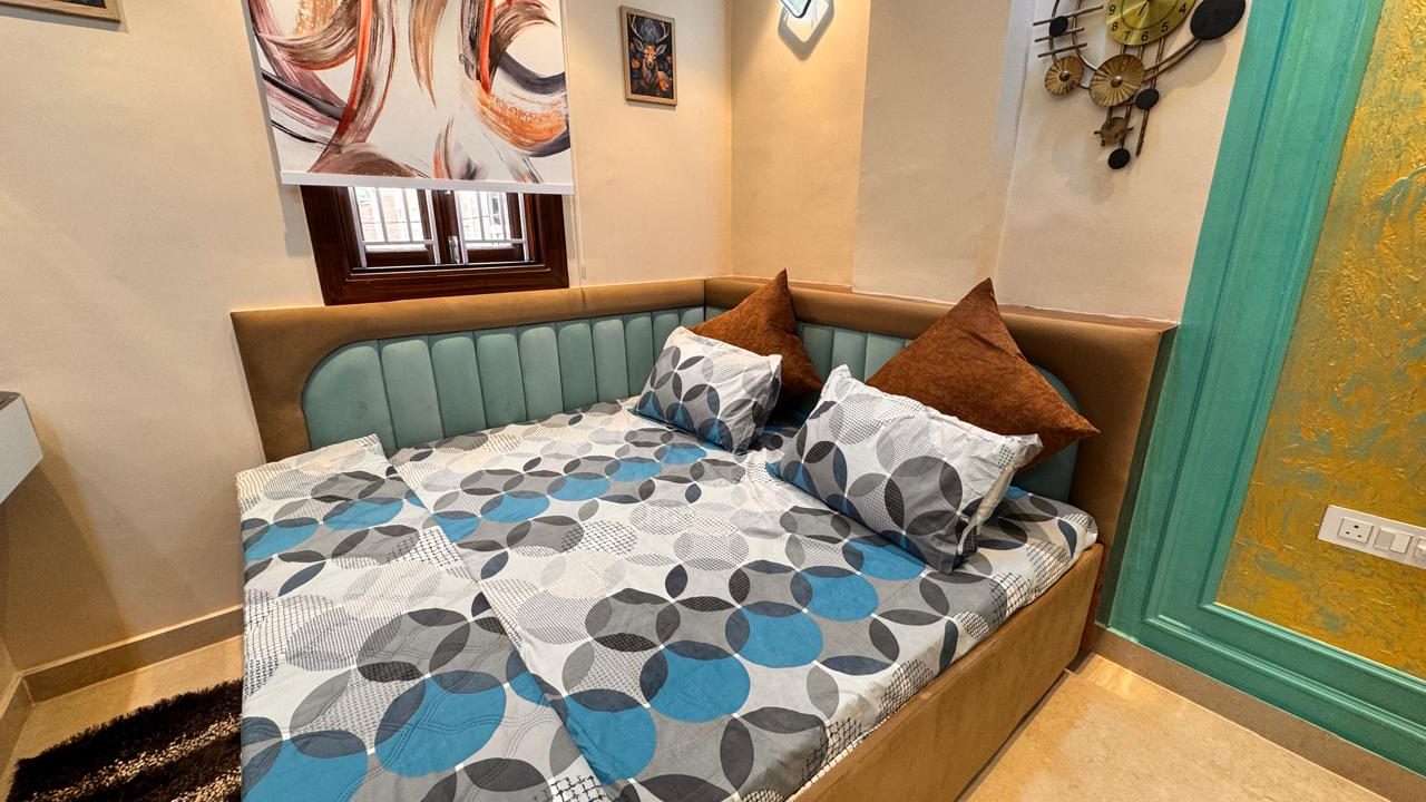 Compact bedroom with designer bed and wall decor