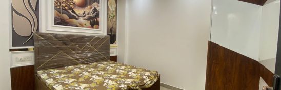 Modern bedroom with bed, wardrobe, and wall art.