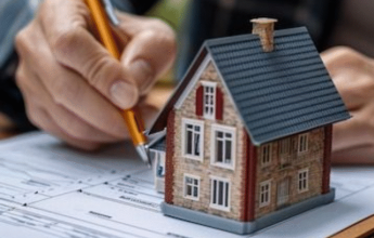 Agent handing house keys to buyer with handshake.