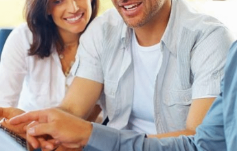Couple discussing paperwork with advisor