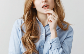 Woman thinking with hand on chin