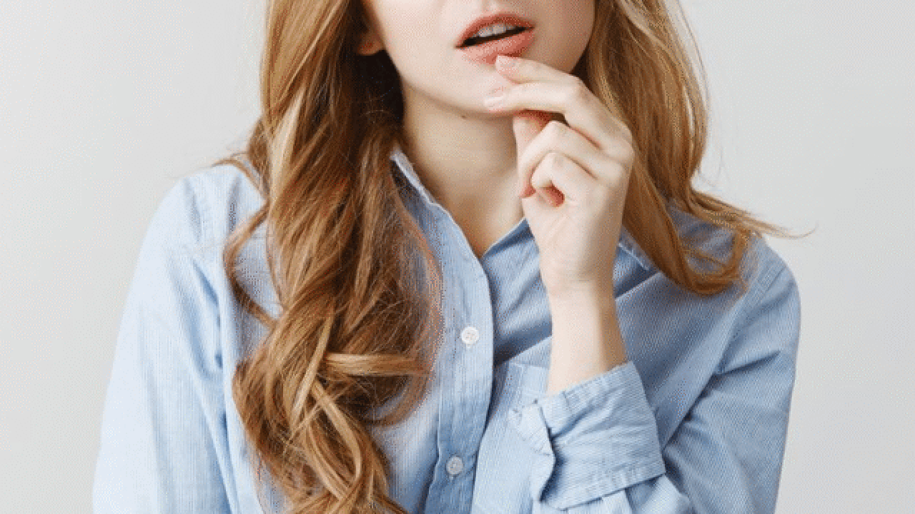 Woman thinking with hand on chin