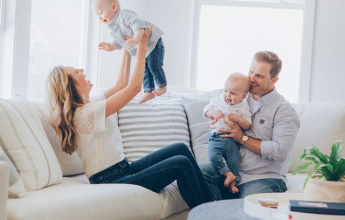 Happy family with twin babies at home