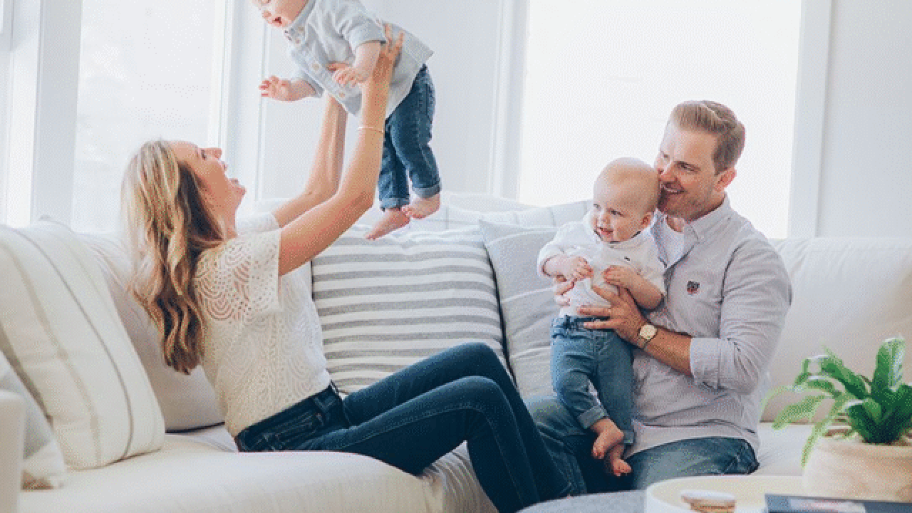 Happy family with twin babies at home