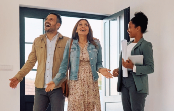 Couple viewing new home with agent