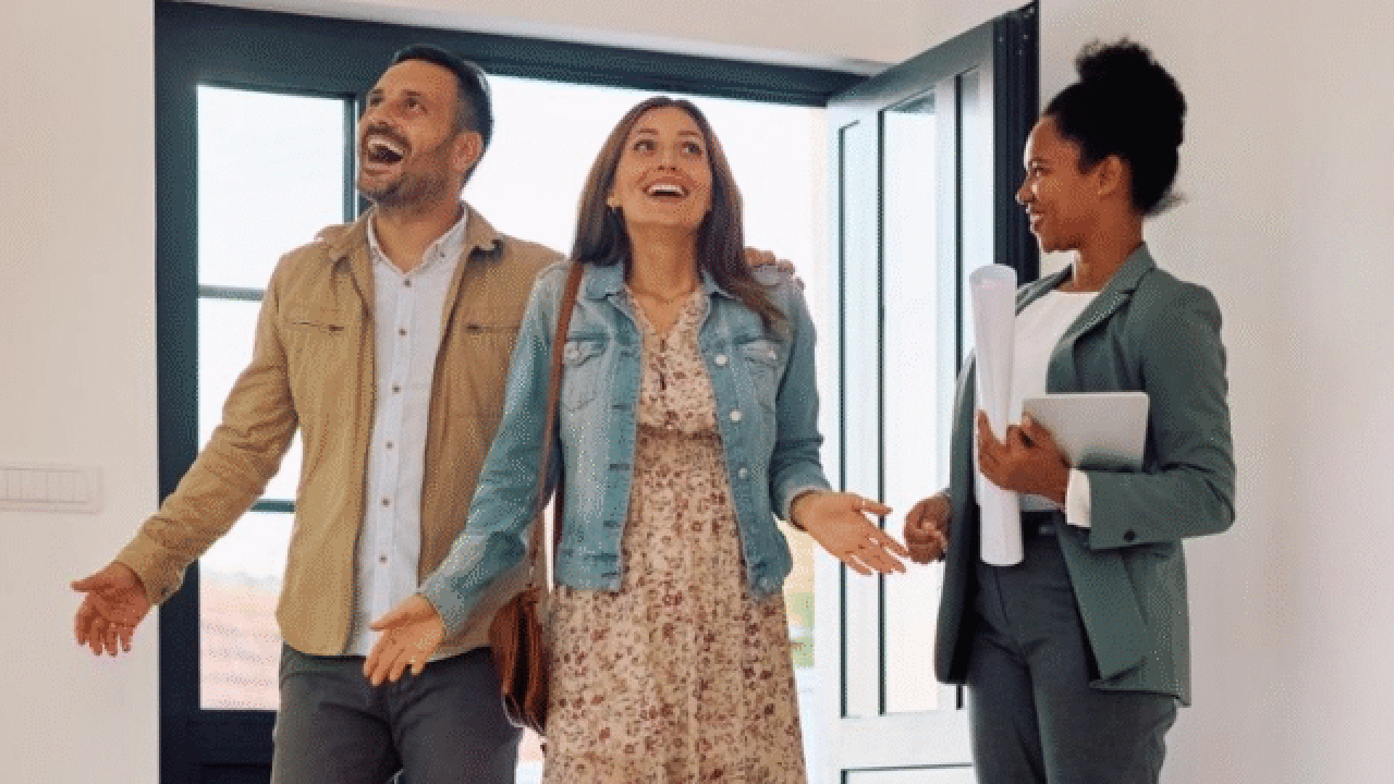 Couple viewing new home with agent