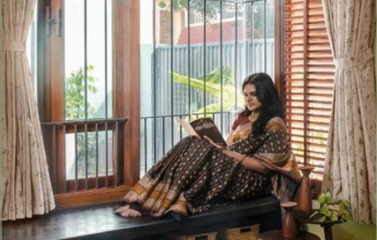 Woman reading by window seat.